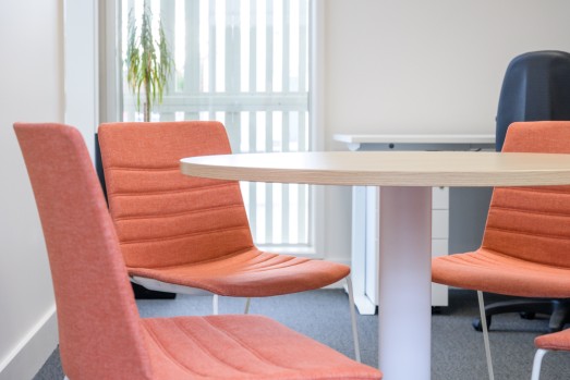 soft orange meeting chairs around a table
